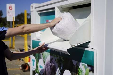 putting bags in the textile recovery box
